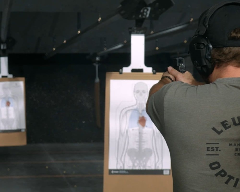 a man shooting at targets on the gun range