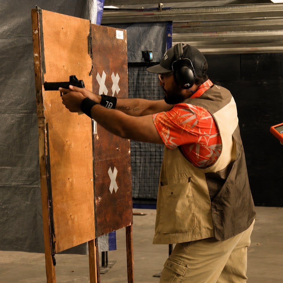 man shooting idpa stage